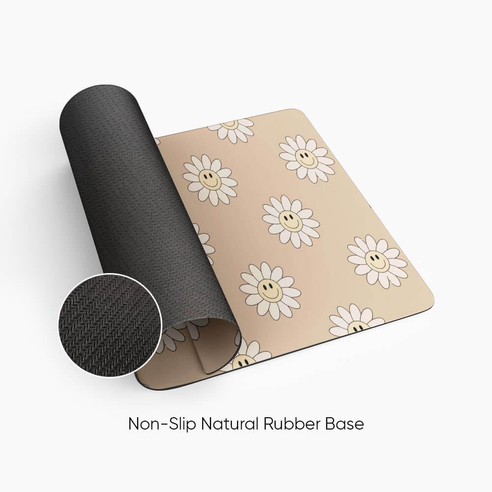 Beige desk mat with smiling daisy flower pattern and non-slip natural rubber base