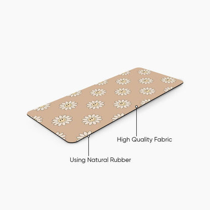 Beige desk mat with daisy flower pattern, labeled high quality fabric and natural rubber.