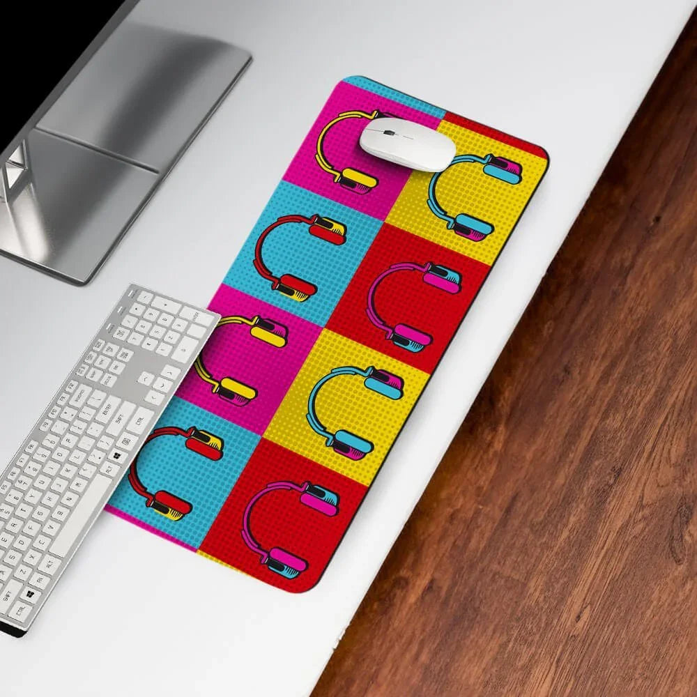 Colorful desk mat with pop art headphone pattern, mouse and keyboard on white desk