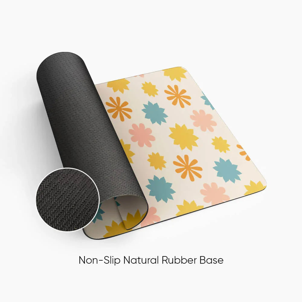 Floral desk mat with pastel yellow, blue, and pink flowers and non-slip natural rubber base