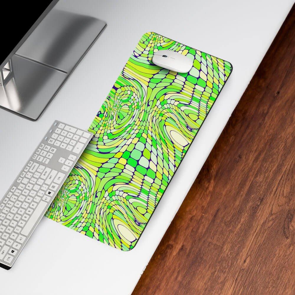 Abstract green and yellow desk mat with geometric pattern on white desk near keyboard and mouse