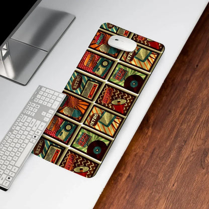 Retro themed desk mat with colorful music and vinyl designs on a modern computer desk