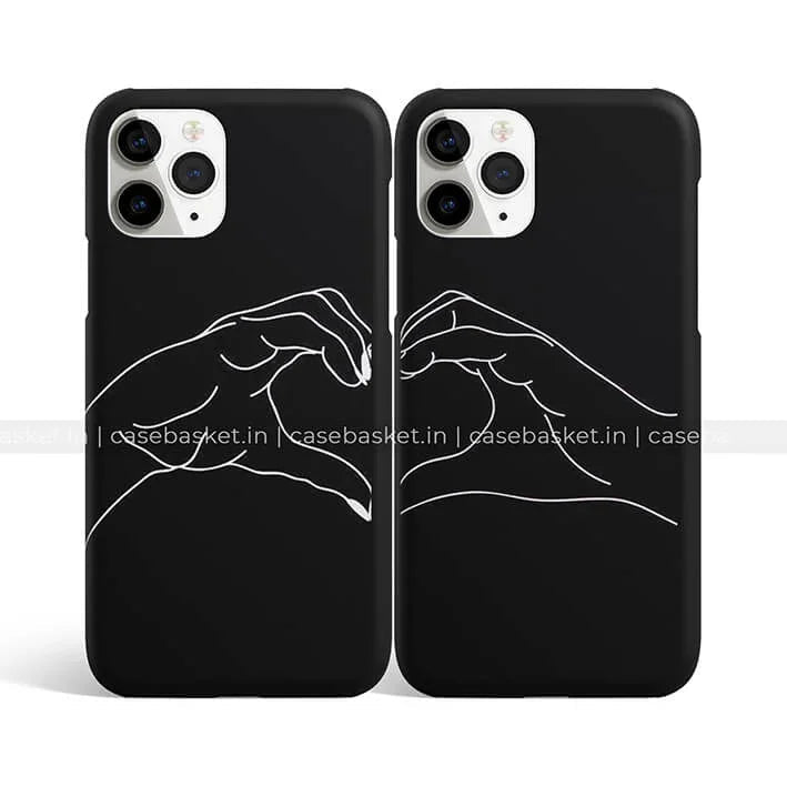 Black couple phone cases with white minimalist hand heart design, perfect for iPhone.