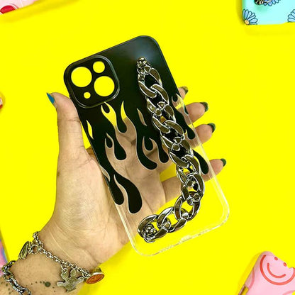 Clear phone case with black flame design and silver chain charm, held in hand on yellow background