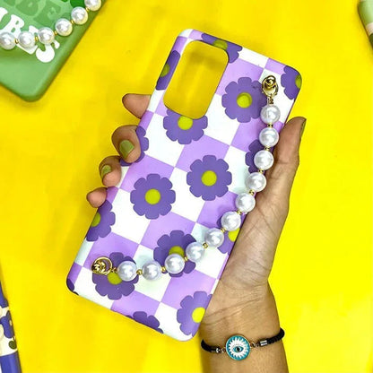 Purple floral checkered phone case with pearl chain strap held in hand, yellow background