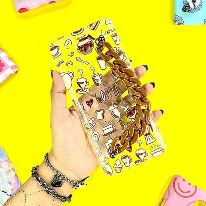Coffee-themed phone case with brown chain charm held in hand, cute doodle design