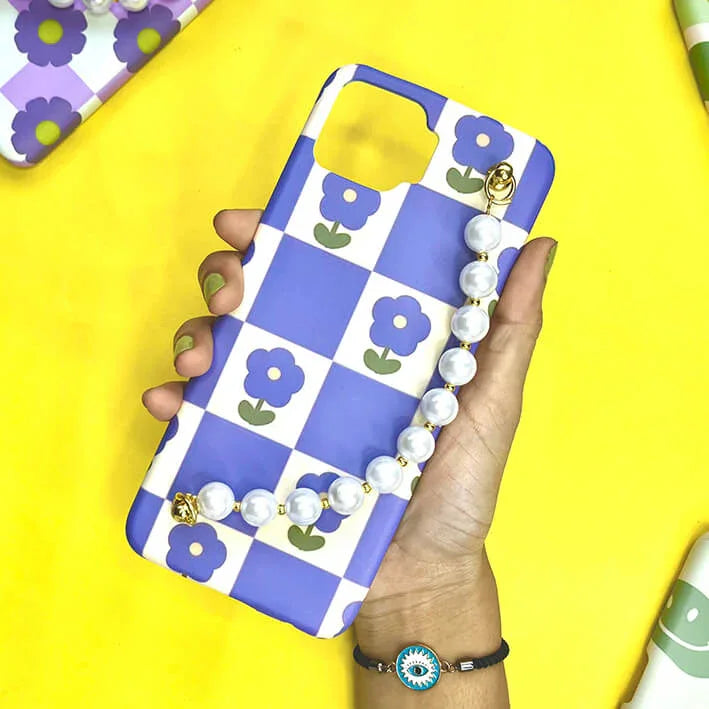 Blue and white checkered phone case with purple flower design and pearl chain charm