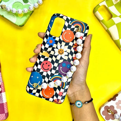 Colorful chain phone case with chequered pattern, smiley faces, rainbows, pearls held in hand