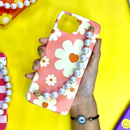 Floral pink phone case with white daisies, heart centers, and pearl chain charm