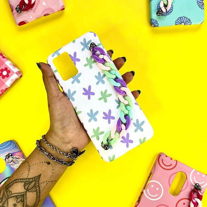 Floral phone case with pastel chain charm held over a yellow background, surrounded by colorful cases.
