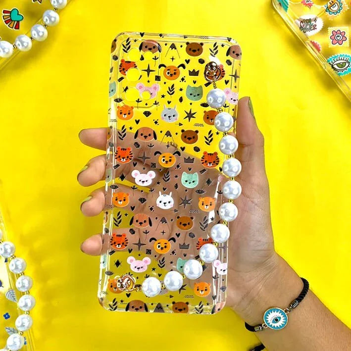 Hand holding cute animal print phone case with pearl chain on yellow background