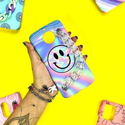 Rainbow smiley face phone case with chain charm held in hand, surrounded by colorful cases.
