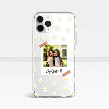 Clear phone case with daisy pattern and Polaroid-style best friends photo, Hey Bestie text