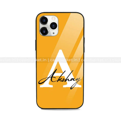 Yellow glossy mobile phone case with large white letter A and Akshay text, stylish design